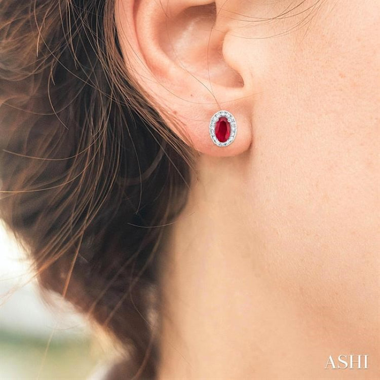 5x3 MM Oval Shape Ruby and 1/8 Ctw Single Cut Diamond Halo Precious Stud Earrings in 10K White Gold 5x3 MM Oval Shape Ruby and 1/8 Ctw Single Cut Diamond Halo Precious Stud Earrings in 10K White Gold