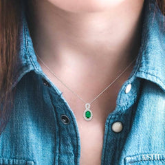 6x4 MM Oval Cut Emerald and 1/10 Ctw Round Cut Diamond Pendant in 10K White Gold with Chain 6x4 MM Oval Cut Emerald and 1/10 Ctw Round Cut Diamond Pendant in 10K White Gold with Chain