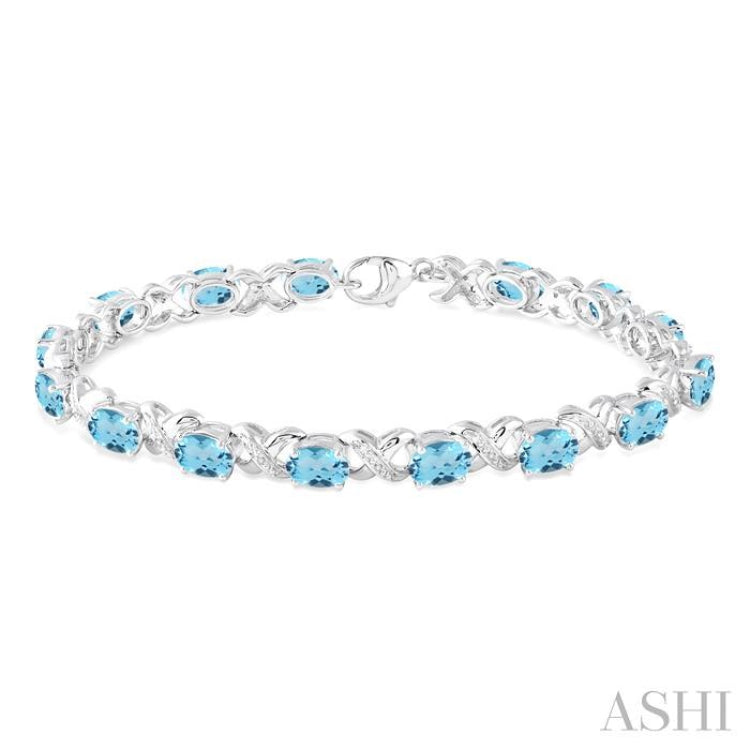 7x5 MM Oval Cut Blue Topaz and 1/20 ctw Round Cut Diamond Fashion Bracelet in Sterling Silver 7x5 MM Oval Cut Blue Topaz and 1/20 ctw Round Cut Diamond Fashion Bracelet in Sterling Silver