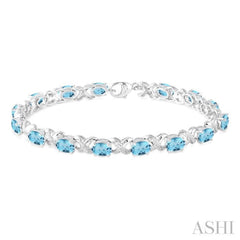 7x5 MM Oval Cut Blue Topaz and 1/20 ctw Round Cut Diamond Fashion Bracelet in Sterling Silver 7x5 MM Oval Cut Blue Topaz and 1/20 ctw Round Cut Diamond Fashion Bracelet in Sterling Silver