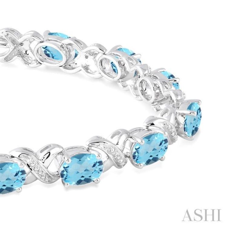 7x5 MM Oval Cut Blue Topaz and 1/20 ctw Round Cut Diamond Fashion Bracelet in Sterling Silver 7x5 MM Oval Cut Blue Topaz and 1/20 ctw Round Cut Diamond Fashion Bracelet in Sterling Silver
