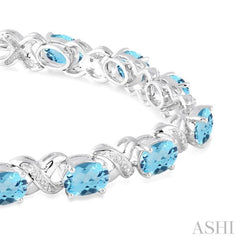 7x5 MM Oval Cut Blue Topaz and 1/20 ctw Round Cut Diamond Fashion Bracelet in Sterling Silver 7x5 MM Oval Cut Blue Topaz and 1/20 ctw Round Cut Diamond Fashion Bracelet in Sterling Silver