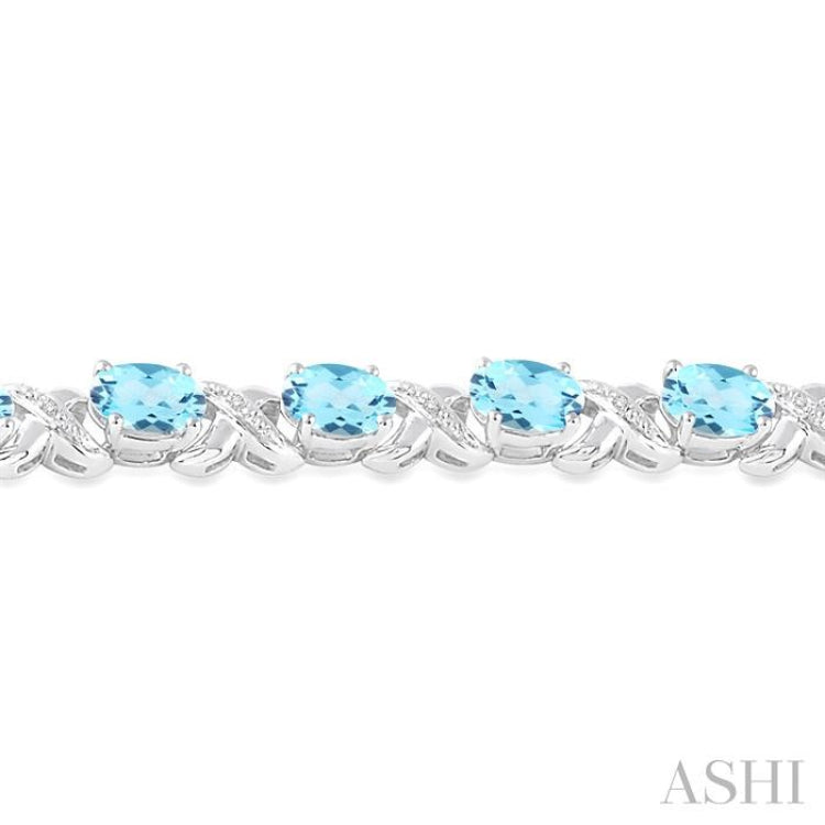 7x5 MM Oval Cut Blue Topaz and 1/20 ctw Round Cut Diamond Fashion Bracelet in Sterling Silver 7x5 MM Oval Cut Blue Topaz and 1/20 ctw Round Cut Diamond Fashion Bracelet in Sterling Silver